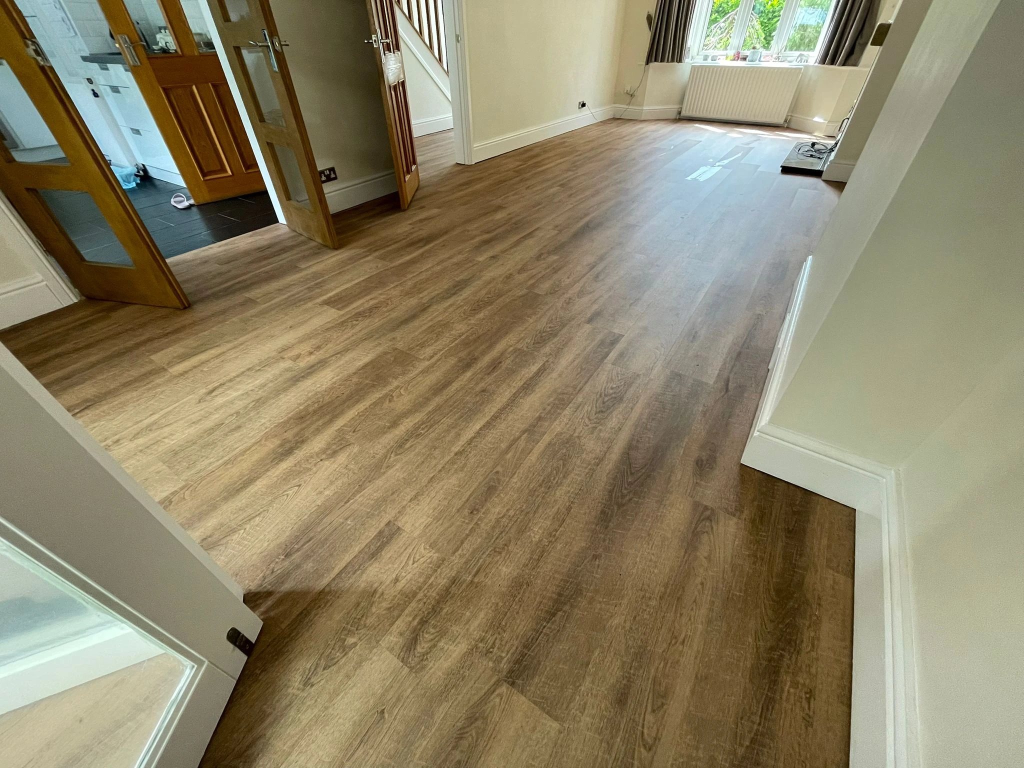 Durable laminate flooring with beveled edges and water-repellent coating in a busy household